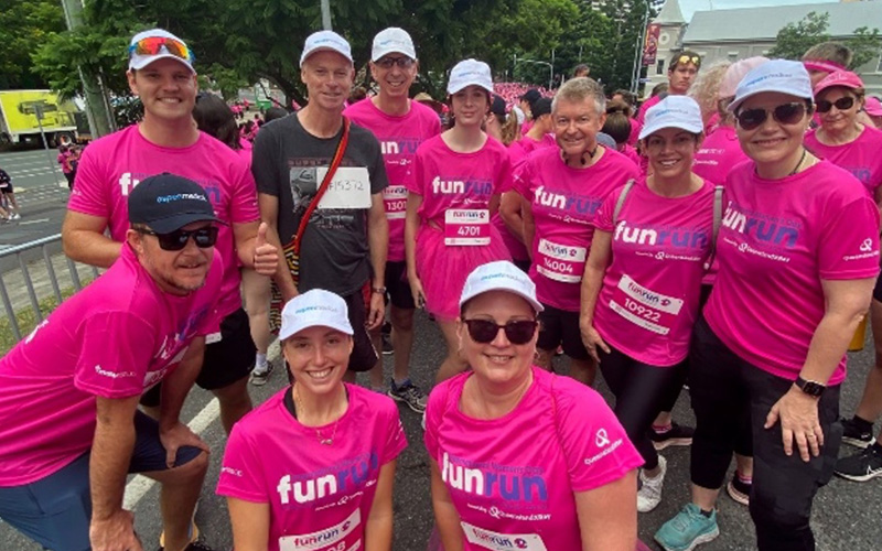 Group of Aspen Medical employees wearing pink tshirts to participate in a charity fun run.